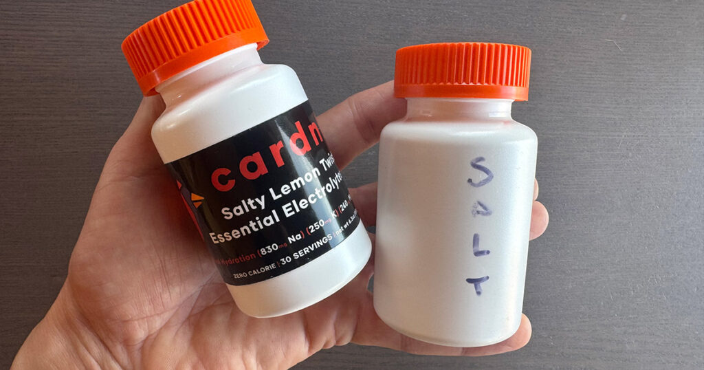 Two supplement bottles, one of salt and one of electrolytes, with desiccant packs
