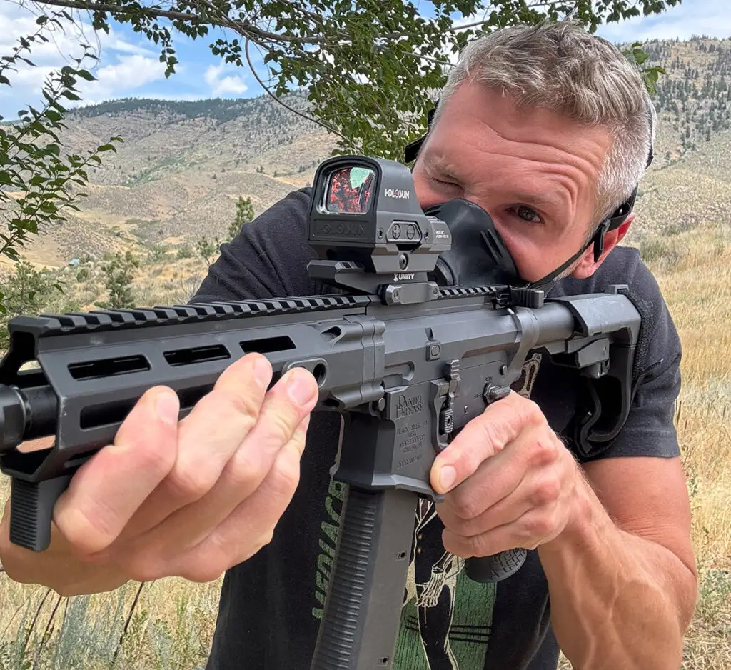 MITR-M1 Half Mask carrying a rifle